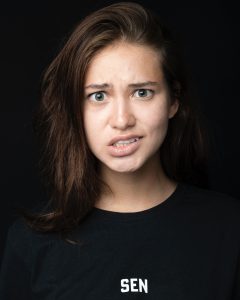 A girl making a confused and frustrated facial expression