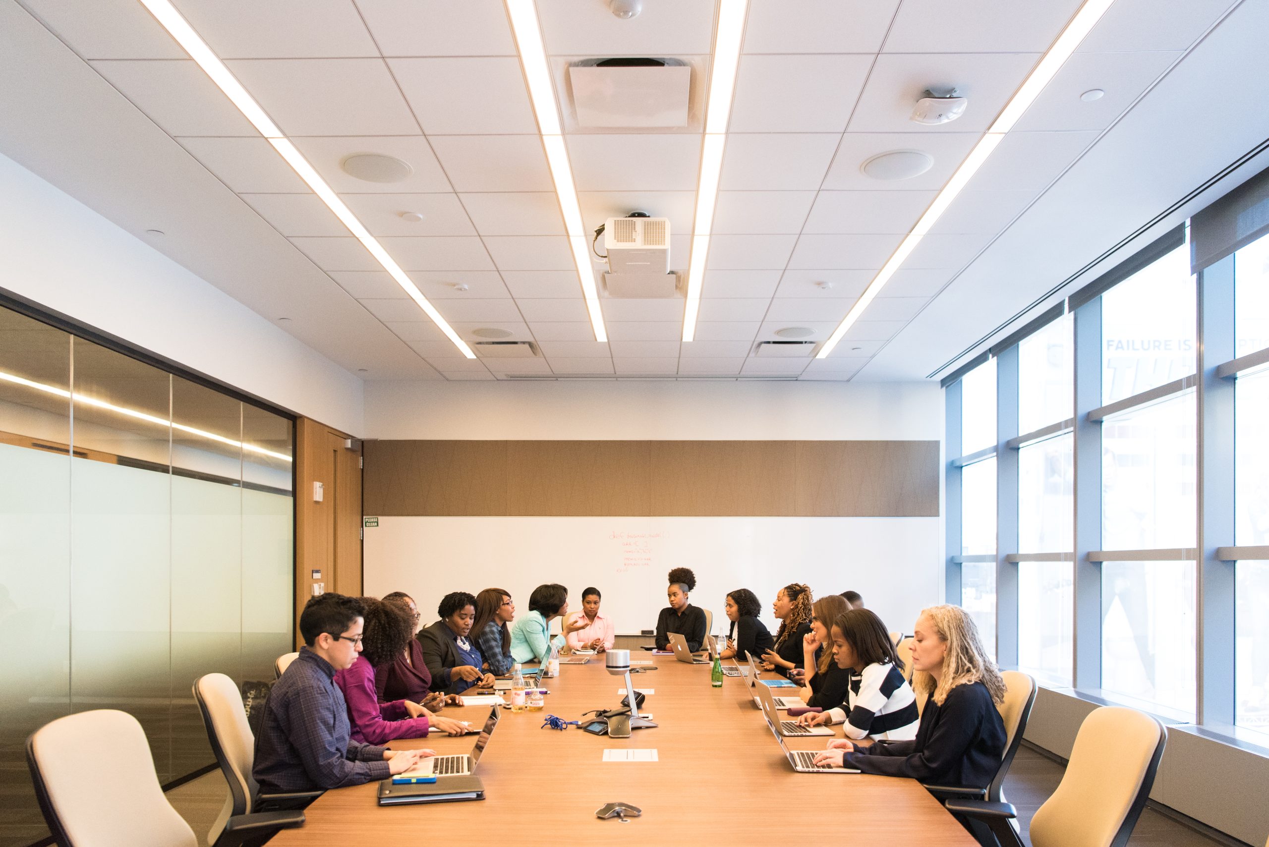 A photo shows a diverse team of business professionals working together on laptops.