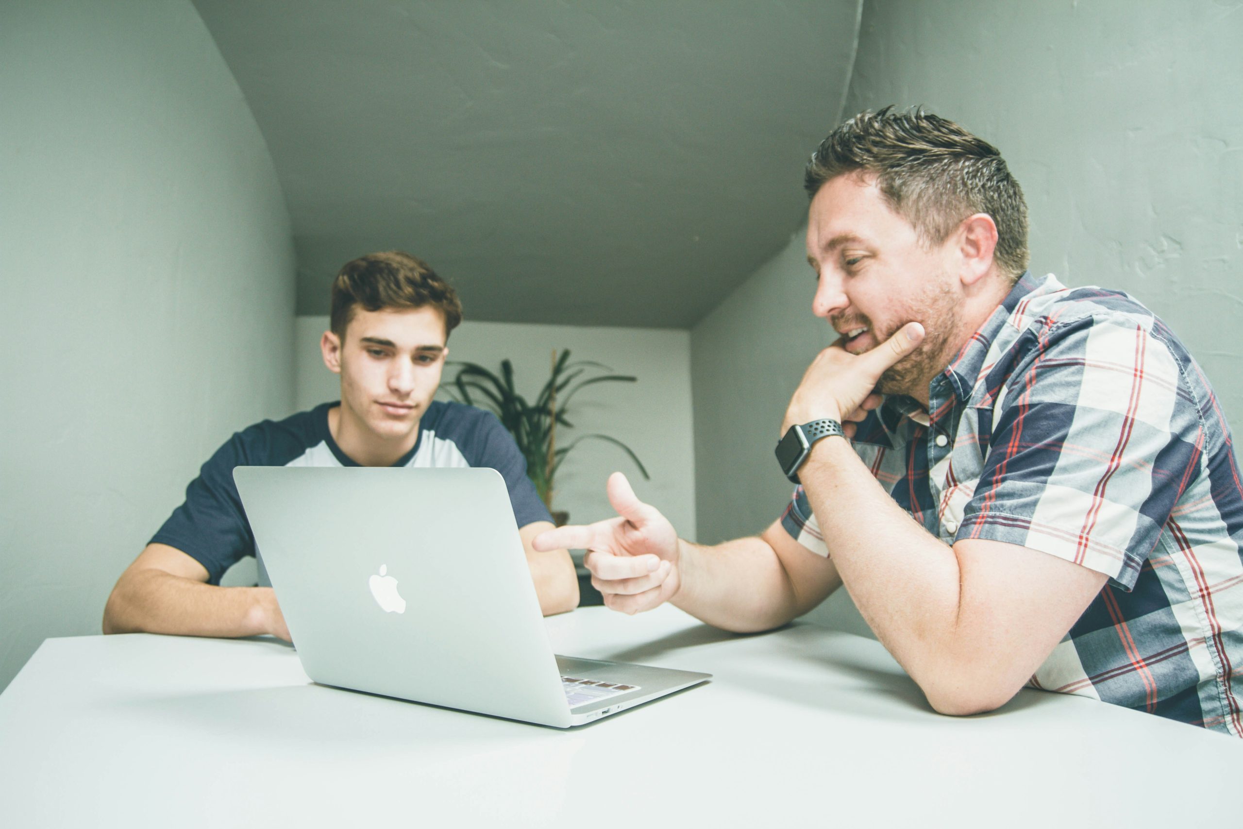 Two People Looking at a Computer