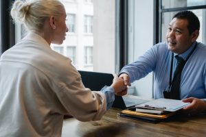 An employee shakes hands with her boss.